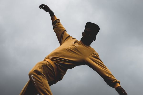 Person performing a controlled, slow lunge to improve flexibility.